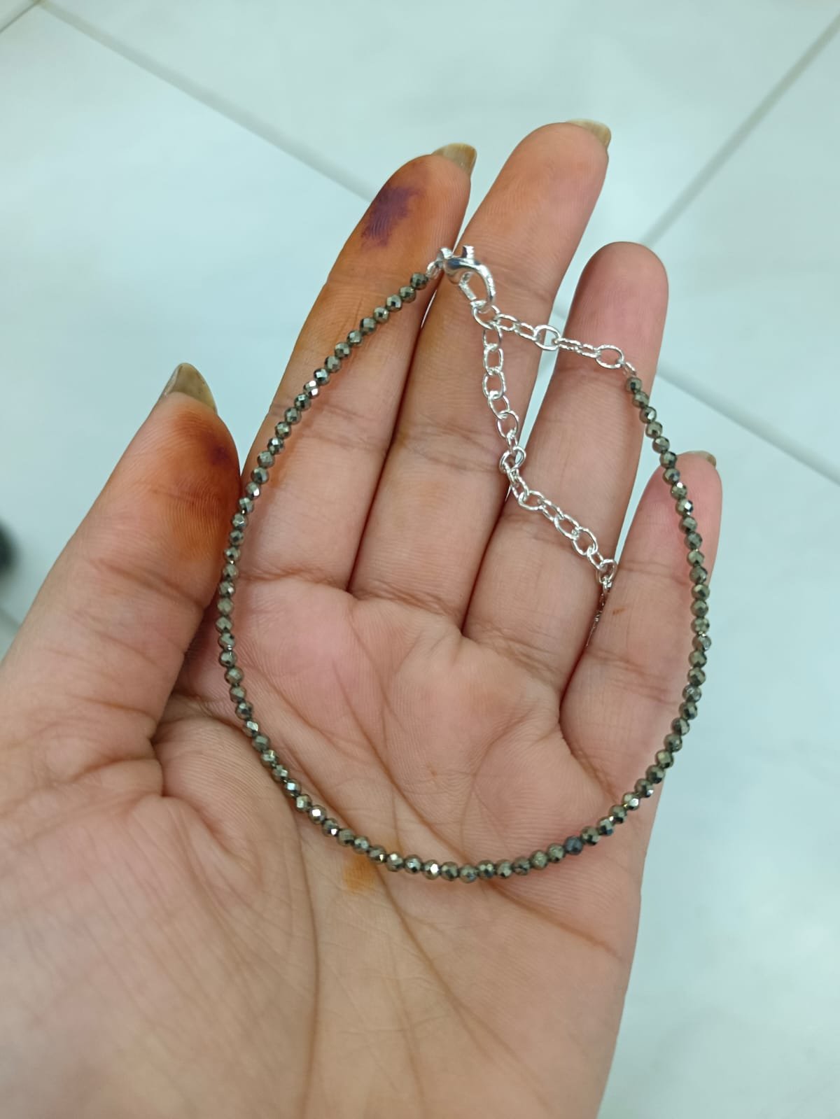 Money Magnet Anklet held in hand showing chain detail